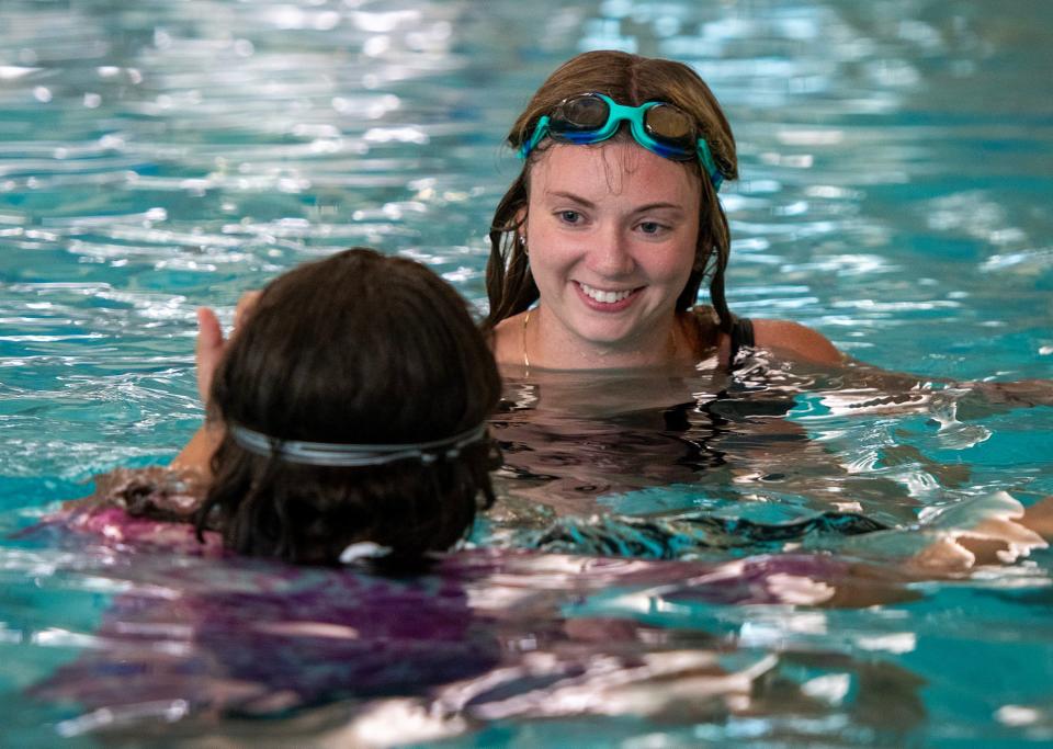 Swim instructor Kendall Lavin-Parsons works with a teenager in the water at the Central Community Branch YMCA Thursday.