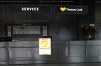 An announcement at a Thomas Cook Airlines counter reads "this counter is closed today" at Duesseldorf Airport