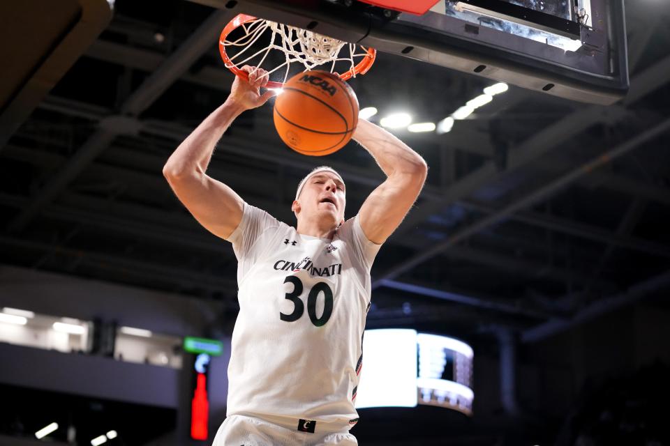 Cincinnati Bearcats forward Viktor Lakhin (30) dunks in the first half of a college basketball game between the UCF Knights and the Cincinnati Bearcats, Saturday, Feb. 4, 2023, at Fifth Third Arena in Cincinnati. 