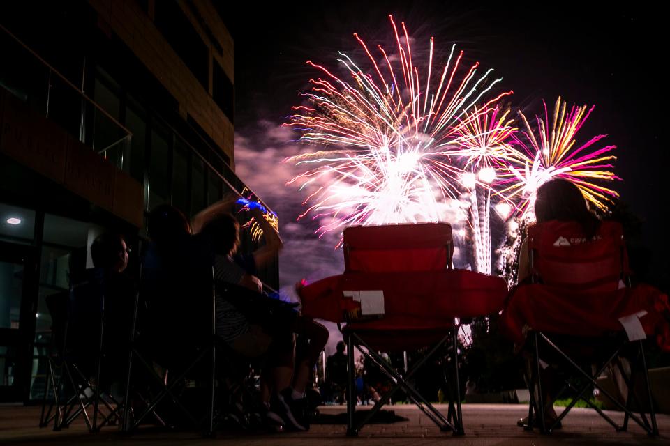 People watch as fireworks explode in the air on the final night of Iowa City Jazz Festival, Saturday, July 3, 2021, in Iowa City, Iowa.