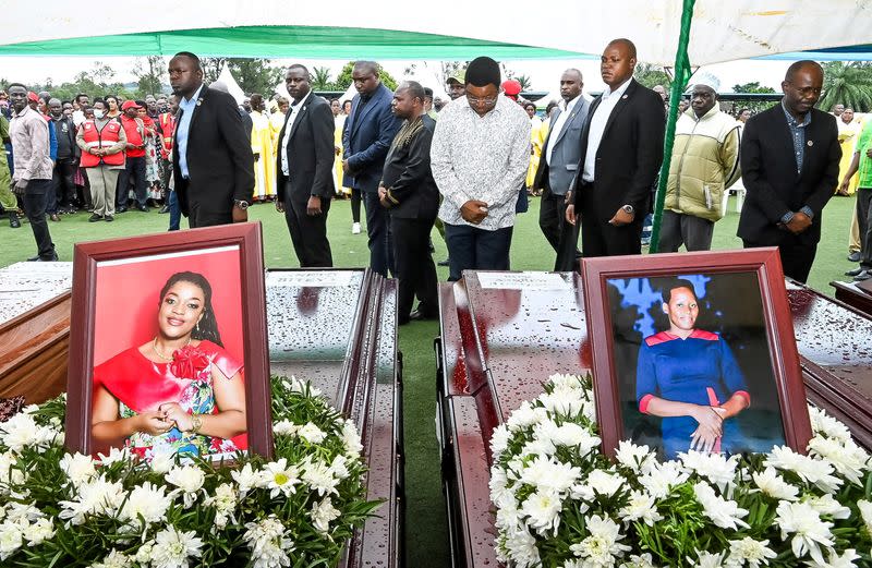 Tanzanian Prime Minister Kassim Majaliwa stands in front of the coffins as he pays homage to the victims following the crash of the Precision Air ATR 42-500 passenger plane into Lake Victoria, at the Kaitaba Stadium in Bukoba