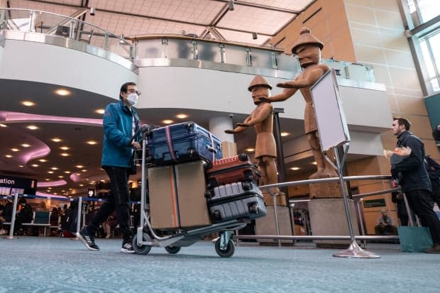 Passengers arrive through international arrivals at Vancouver’s international airport (YVR) in Richmond, British Columbia on Tuesday, Jan. 28, 2020. 