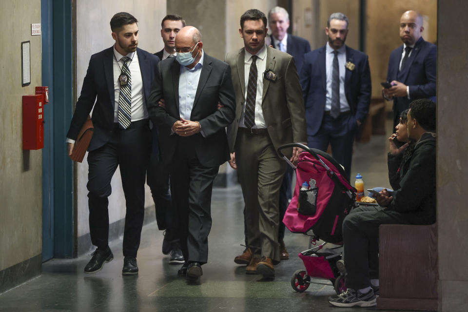 Allen Weisselberg, second from left, is escorted to Manhattan criminal court, Monday, March 4, 2024, in New York. Weisselberg, the former chief financial officer of the Trump Organization, surrendered to the Manhattan district attorney Monday morning for arraignment on new criminal charges, the prosecutor's office said. (AP Photo/Yuki Iwamura)