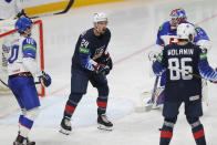 Sasha Chmelevski of the US, center, celebrates after scoring his side's fifth goal during the Ice Hockey World Championship quarterfinal match between the United States and Slovakia at the Arena in Riga, Latvia, Thursday, June 3, 2021.(AP Photo/Sergei Grits)