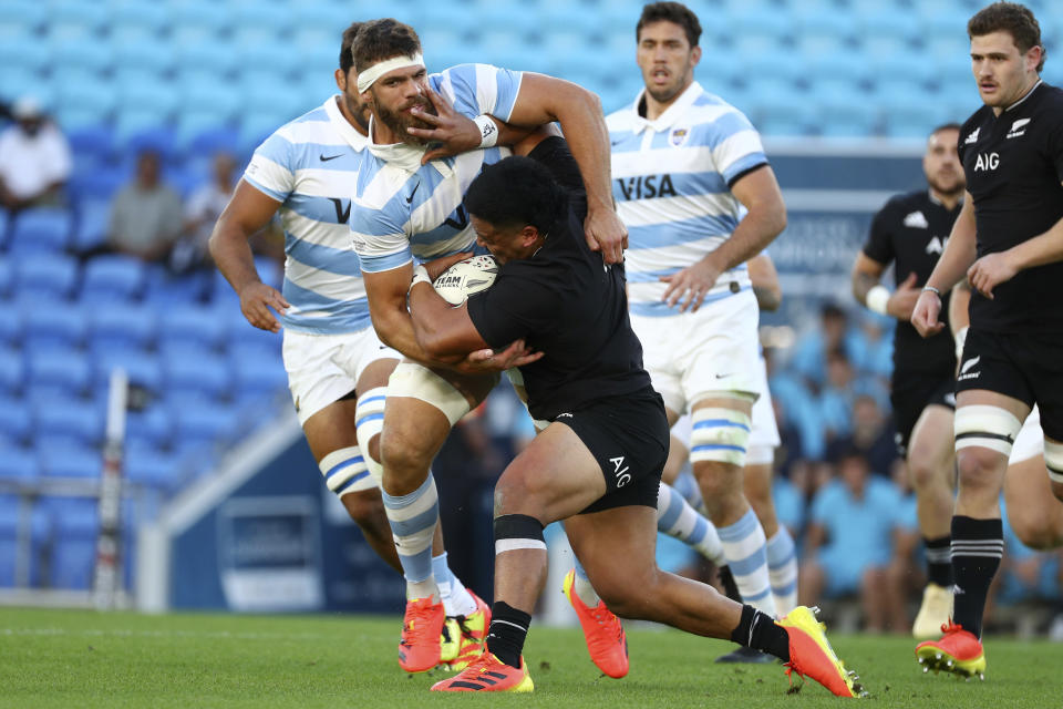 Argentina's Marcos Kremer, left, tackles New Zealand's Asafo Aumua during their Rugby Championship match on Sunday, Sept. 12, 2021, on the Gold Coast, Australia. (AP Photo/Tertius Pickard)