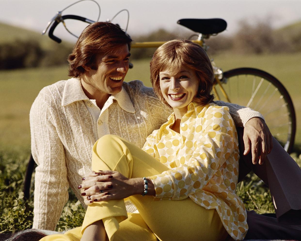 1970 couple sitting in the grass