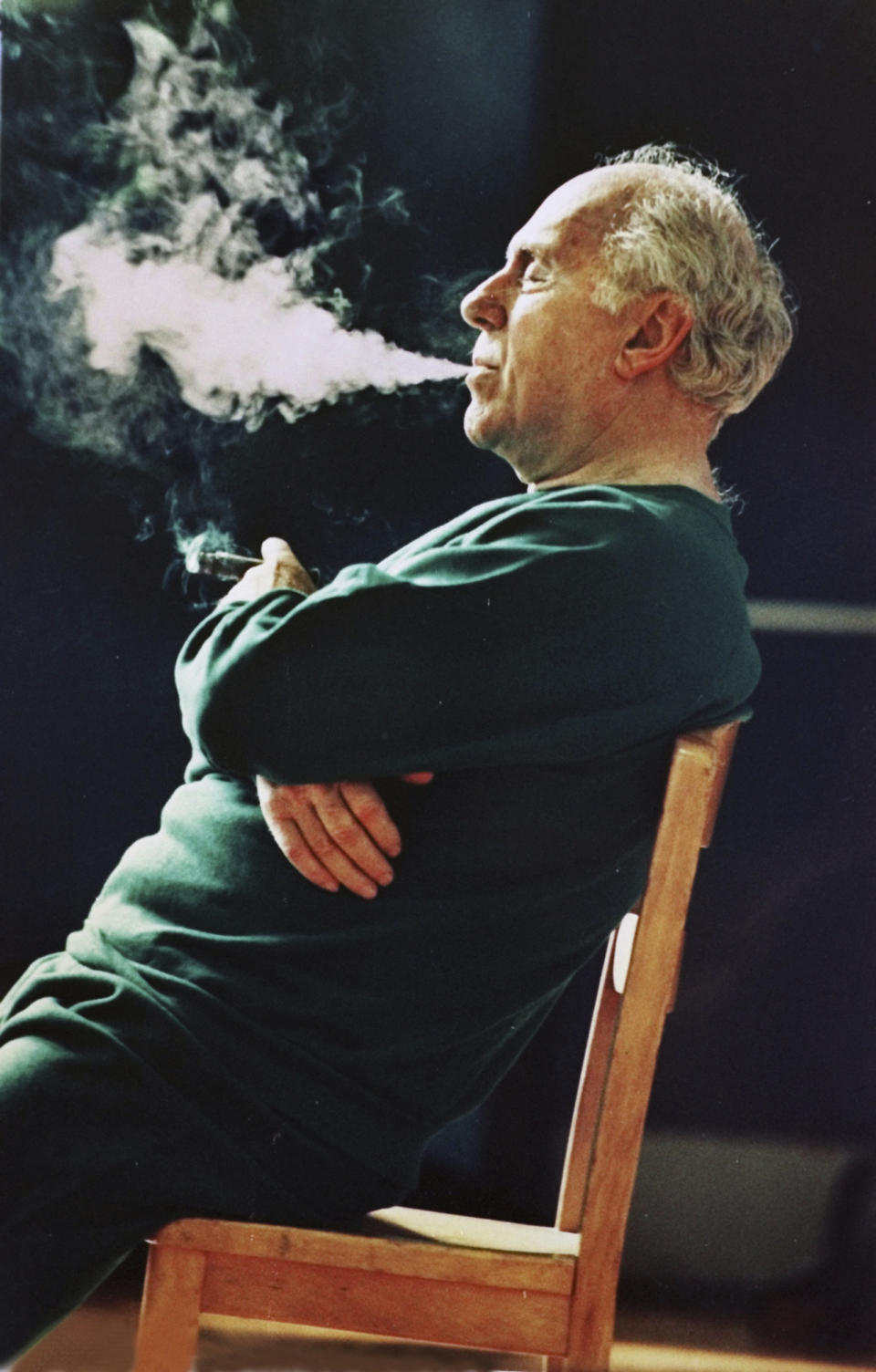 FILE - This photo by Associated Press photographer Elise Amendola shows legendary Boston Celtics coach and president Red Auerbach leaning back in his chair and puffing a cigar while watching team practice at Hellenic College in Brookline, Mass., May 23, 1988. Amendola, who recently retired from the AP, died Thursday, May 11, 2023, at her home in North Andover, Mass., after a 13-year battle with ovarian cancer. She was 70. (AP Photo/Elise Amendola, File)