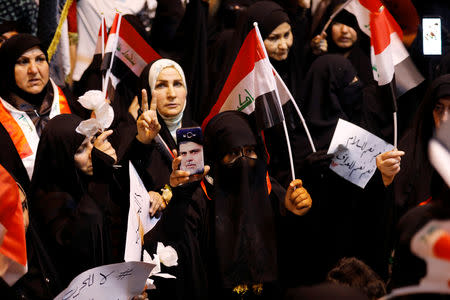 A supporter of Iraqi Shi'ite cleric Moqtada al-Sadr shows the victory sign during a protest calling for neutrality during the ongoing tensions between neighbouring Iran and the USA, at Tahrir square in Baghdad, Iraq May 24, 2019. REUTERS/Khalid Al-Mousily