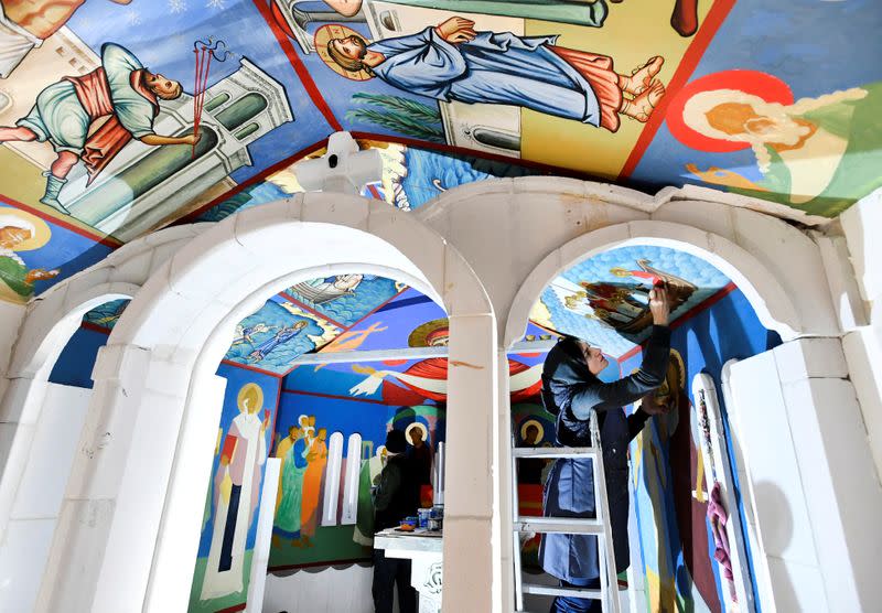 Georgian restorers work on frescoes at the chapel of a mobile Georgian Orthodox monastery in Vlissingen