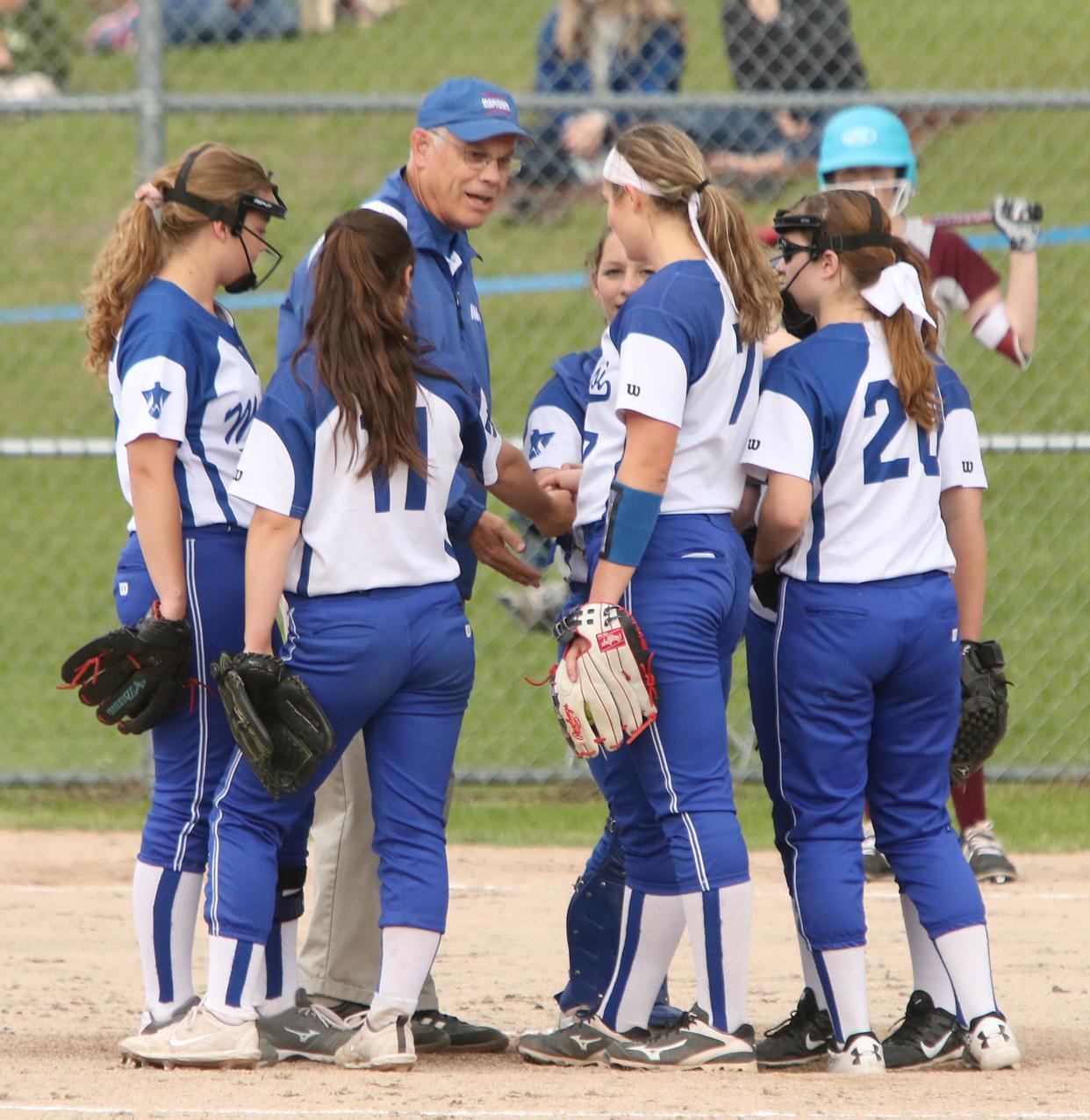 MVU coach Jay Hartman lightens the mood during a visit to the pitchers circle in the T-Birds’ 5-1 win over Lyndon in the Division I softball semifinals in Swanton on Tuesday, June 4, 2019.