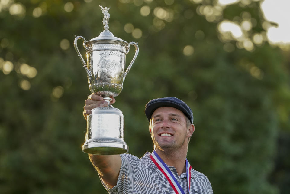 FILE - In this Sept. 20, 2020, file photo, Bryson DeChambeau, of the United States, holds up the winner's trophy after winning U.S. Open golf tournament in Mamaroneck, N.Y. DeChambeau took a month off ahead of the Masters to work on a 48-inch driver with hopes of dismantling Augusta National in November. (AP Photo/John Minchillo, File)