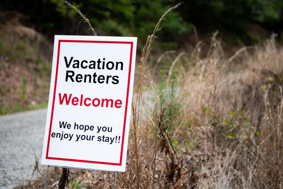 A sign reading "Vacation renters welcome. We hope you enjoy your stay!" is displayed along Mountain Shores Road in the Lone Mountain Shores community in New Tazewell on Wednesday, July 26, 2023.