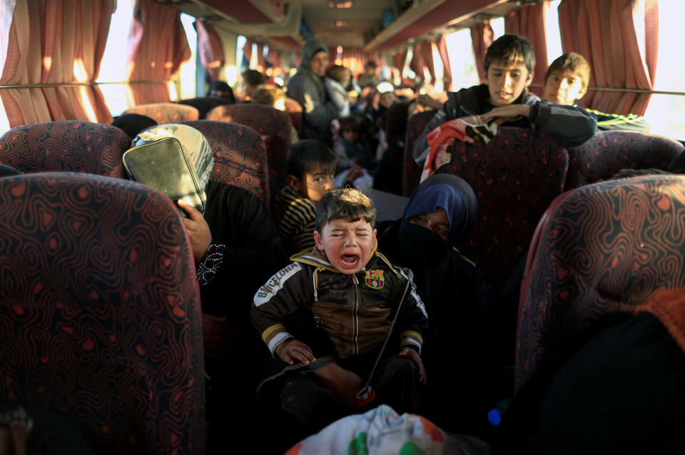 <p>A boy who just fled a village controlled by Islamic State fighters cries as he sits with his family in a bus before heading to the camp at Hamam al-Alil, south of Mosul, Iraq, Feb. 22, 2017. (Zohra Bensemra/Reuters) </p>