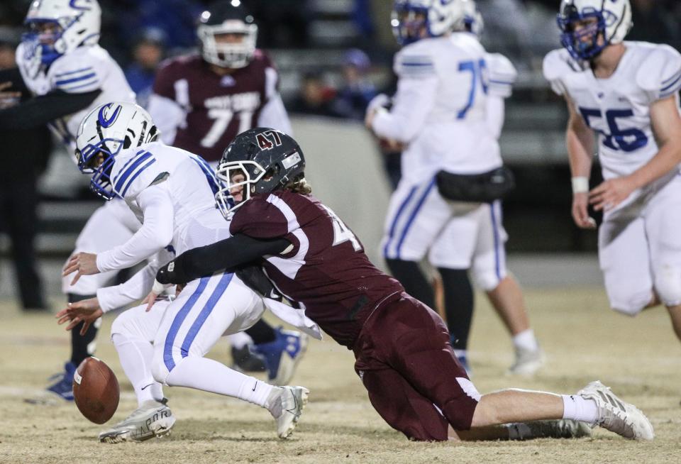 Holy Cross' Luke McCubbins tackles Crittenden County's Micah Newcom in the first half of the third round Class A high school football Friday night at Pleasure Ridge Park. Nov. 18, 2022.