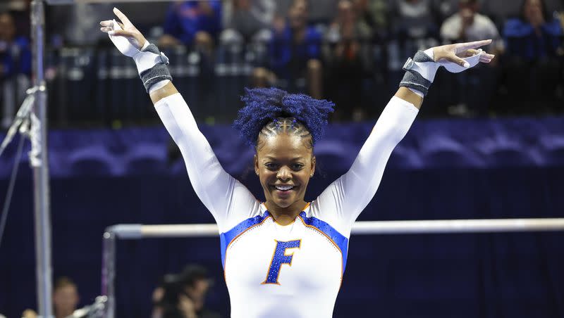 Florida’s Trinity Thomas reacts after competing on the uneven bars during an NCAA gymnastics meet against Georgia on Friday, Jan. 27, 2023, in Gainesville, Fla. Thomas, the 2022 NCAA champion while competing for Florida, says she is going to make a bid for the 2024 U.S. women’s Olympic gymnastics team. 