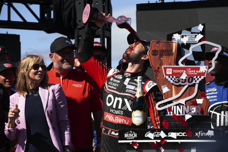Daniel Suarez pours wine on his face from the winner's goblet at a NASCAR Cup Series race, Sunday, June 12, 2022, at Sonoma Raceway in Sonoma, Calif. (AP Photo/D. Ross Cameron)