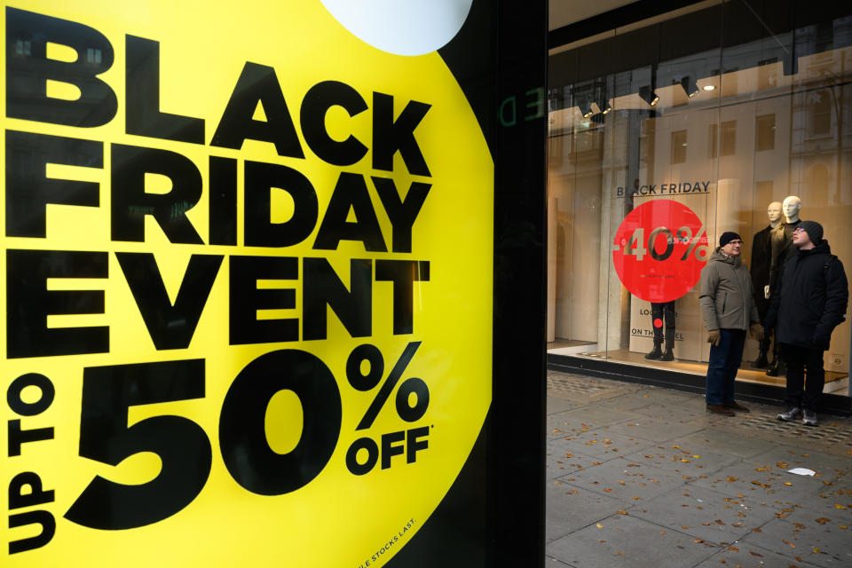 Signs advertising Black Friday sales are seen in the Oxford Street shopping district 