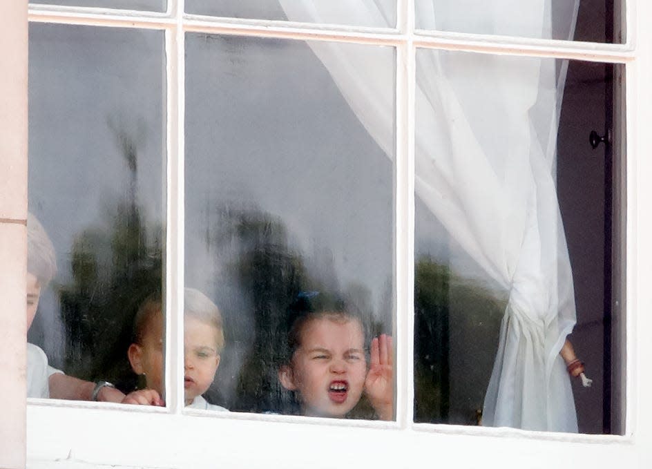 Prince George, Princess Charlotte, and Prince Louis look out a window
