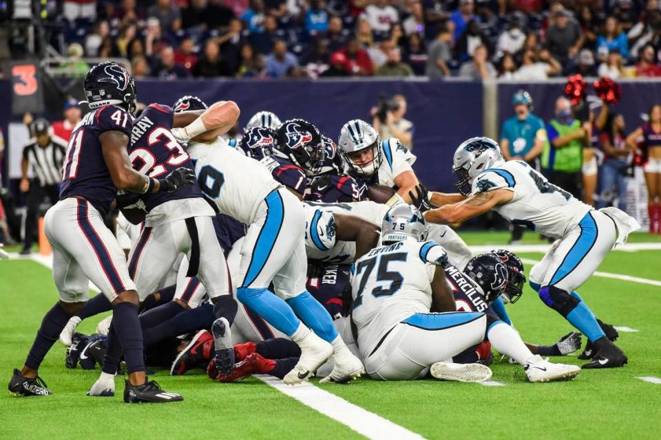 Panthers quarterback Sam Darnold, second from back right, pushes through the scrum toward the end zone in the fourth quarter Thursday. Darnold made it into the end zone to score a 1-yard touchdown, giving the Panthers their third touchdown and sealing their victory over the Texans, 24-9.