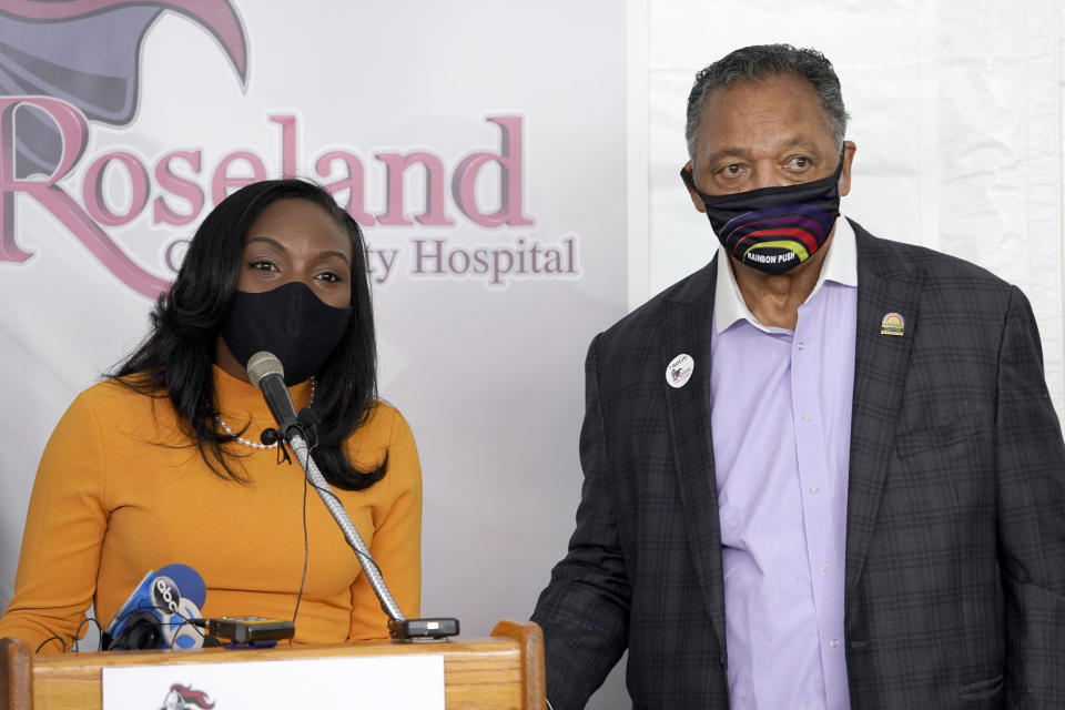 FILE - In this Jan. 8, 2021, file photo, Kizzmekia Corbett, left, an immunologist with the Vaccine Research Center at the National Institute of Health, and the Rev. Jesse Jackson, respond to questions after Jackson received his first COVID-19 vaccine at the Roseland Community Hospital in Chicago. Corbett, a Black U.S. government scientist who helped develop Moderna's vaccine, acknowledges ''centuries of medical injustice'' against Black Americans but said COVID-19 vaccines resulted from years of solid research. Trust in those vaccines, she said, is needed to save lives. (AP Photo/Charles Rex Arbogast, File)