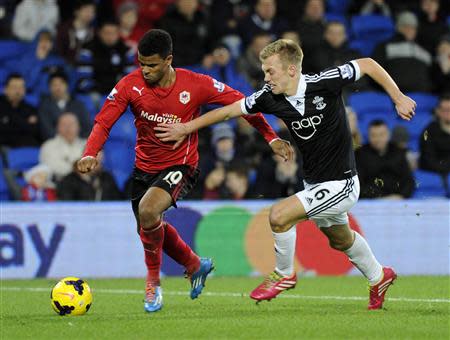 Cardiff City's Fraizer Campbell (L) is challenged by Southampton's James Ward-Prowse during their English Premier League soccer match at Cardiff City Stadium, Wales, December 26, 2013. REUTERS/Rebecca Naden