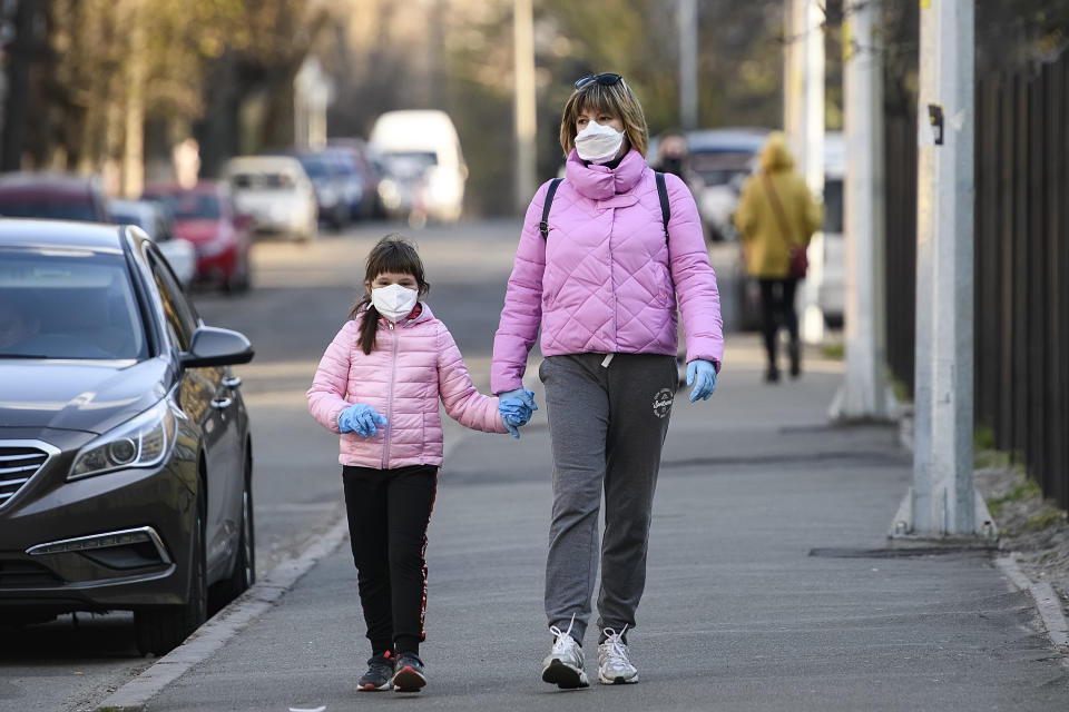 Woman with child in protective masks as a preventive measure against the coronavirus COVID - 19 on street in Kyiv, Ukraine on April 04, 2020 (Photo by Maxym Marusenko/NurPhoto via Getty Images)