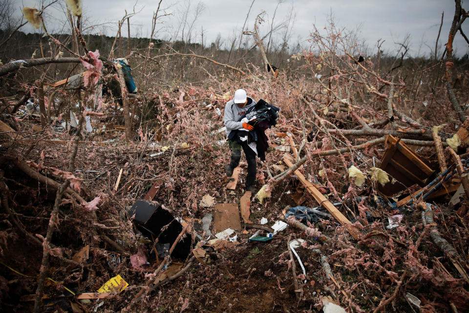 Dax Leandro salvages clothing from the wreckage of his friend's home after two back-to-back tornadoes touched down, in Beauregard, Alabama, March 4, 2019. (Photo: Elijah Nouvelage/Reuters)