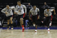 Chicago Bulls Jabari Parker, from left, Cristiano Felicio, Kris Dunn and Shaquille Harrison, warm up at the start of a basketball practice at the Mexico City Arena in Mexico City, Wednesday, Dec. 12, 2018. The Bulls will face Orlando Magic Thursday in the first of two 2018 regular-season NBA games to be played in the high-altitude Mexican capital. (AP Photo/Rebecca Blackwell)