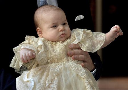 Britain's Prince William carries his son Prince George as they arrive for his son's christening at St James's Palace in London October 23, 2013. REUTERS/John Stillwell/pool