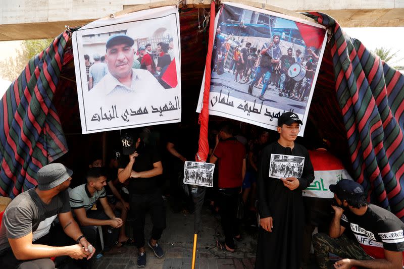 Iraqi demonstrators gather at a memorial for a protester, who was killed last night during the ongoing anti-government protest due to poor public services at Tahrir Square in Baghdad