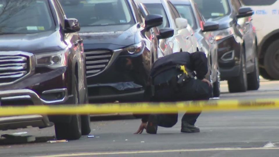 <div>An NYPD officer checks under a car at a crime scene in Bed-Stuy on Wednesday, Dec. 21, 2022.</div>