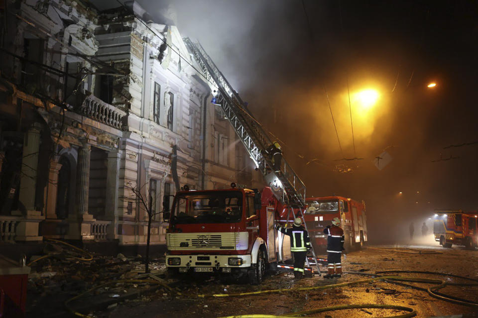In this photo provided by the Ukrainian Emergency Service, firefighters put out a fire after Russia's missile attack in Kharkiv, Ukraine, Sunday, Dec. 31, 2023. (Ukrainian Emergency Service via AP)