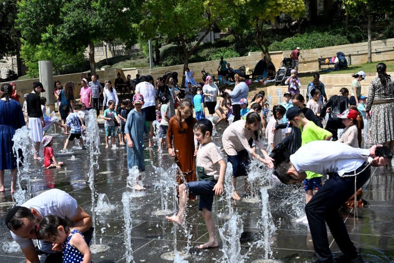 Children cool off in a water fountain near Jerusalem's Old City on August 13 as temperatures reached 39 degrees Celsius, or 102 degrees Fahrenheit during a scorching heat wave. File Photo by Debbie Hill/UPI