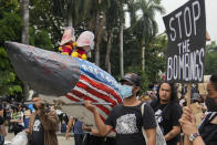 A picture of Philippine President Ferdinand Marcos Jr. and U.S. President Joe Biden are placed on top of a mock rocket with a US flag design during a rally as they commemorate International Human Rights Day, Saturday, Dec. 10, 2022, in Manila, Philippines. Hundreds of people marched in the Philippine capital on Saturday protesting what they said was a rising number of extrajudicial killings and other injustices under the administration of President Ferdinand Marcos Jr. (AP Photo/Aaron Favila)