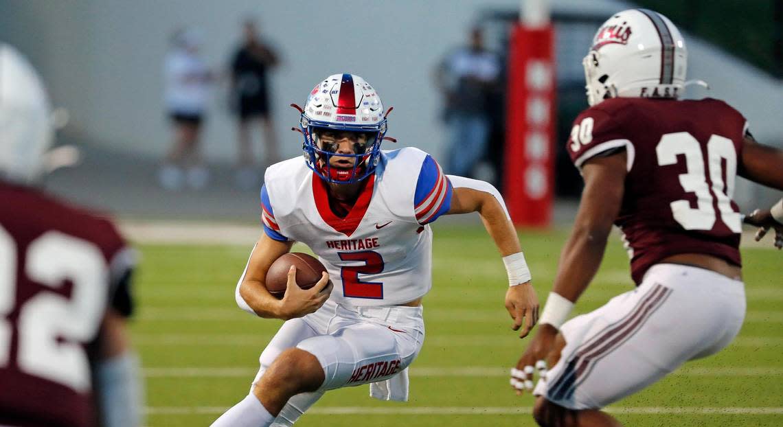 Heritage quarterback Kaden Brown (2) scrambles out of the backfield in the first half of a District 5-5A Division II high school football game at Midlothian ISD Multi-use Stadium in Midlothian, Texas, Friday, Oct. 14, 2022. Midlothian led Ennis 20-7 at the half. (Special to the Star-Telegram Bob Booth) Bob Booth/Bob Booth