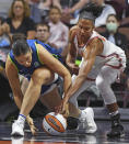 Minnesota Lynx forward Natalie Achonwa (11) and Connecticut Sun forward Alyssa Thomas (25) tangle for the ball during a WNBA basketball game Sunday, Aug. 14, 2022, in Uncasville, Conn. (Sean D. Elliot/The Day via AP)