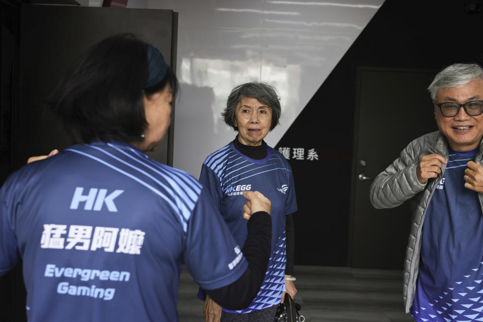 Sixty five-year-old esport player Chiang Yi-Shu, center, talks to her teammates of the team Evergreen Gaming in Taichung, Taiwan on Saturday, Dec. 17, 2022. Chiang is one of the League of Legends players on Hungkung Evergreen Gaming's team, established this summer. The team, whose members range from 62 to 69 years old, was founded by Huang Jianji, the director of the department of Multimedia Game development and application of Hungkuang University. They competed in their first-ever video game tournament Saturday at the university. (AP photo/I-Hwa Cheng)