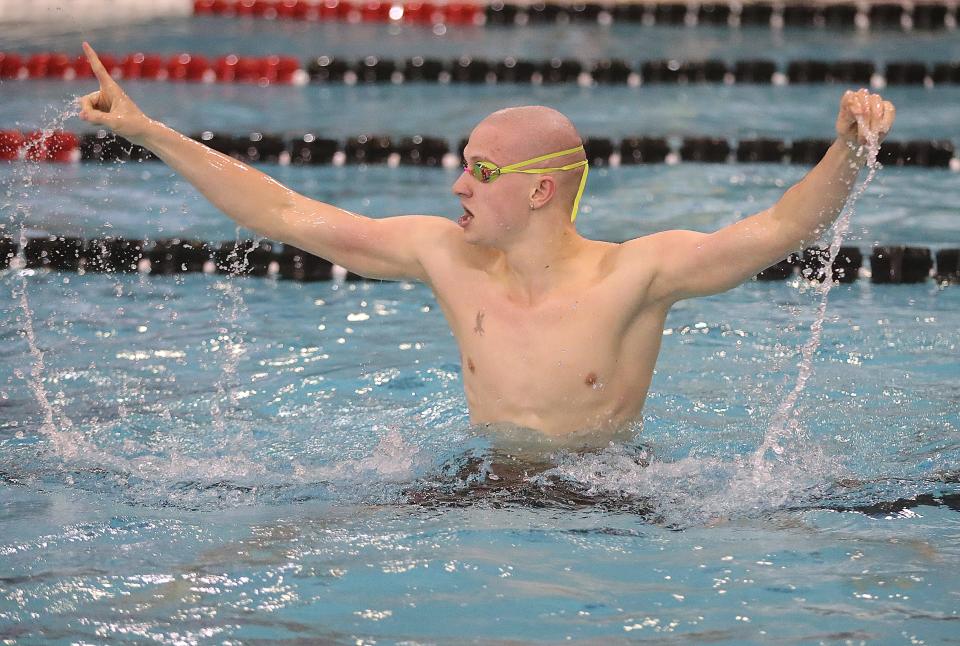 Firestone senior Jonny Marshall celebrates his state championship win in the 100 yard backstroke event during the Ohio High School Division I state championship meet on Saturday, Feb. 25, 2023 in Canton, Ohio, at C.T. Branin Natatorium.