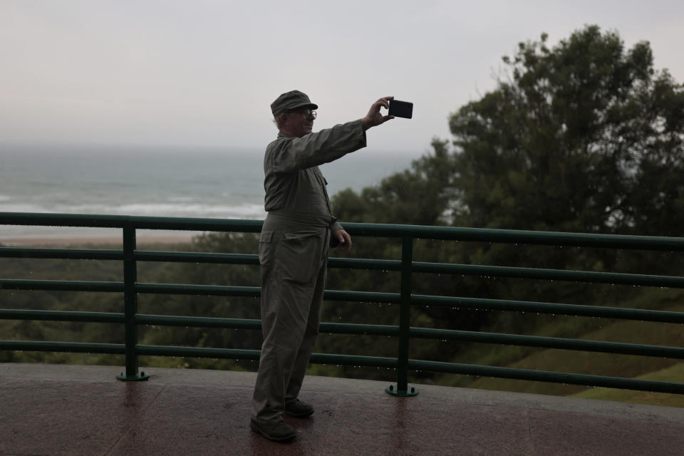 A tourist makes a selfie of the beach side from the US cemetery of Colleville-sur-Mer, Normandy, Saturday, June, 4 2022. Several ceremonies will take place to commemorate the 78th anniversary of D-Day that led to the liberation of France and Europe from the German occupation. (AP Photo/Jeremias Gonzales)