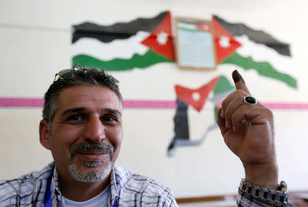 A Jordanian man shows his ink-stained finger after casting his ballot at a polling station for parliamentary elections in Amman, Jordan September 20, 2016. REUTERS/Muhammad Hamed