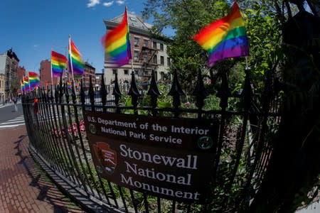 FILE PHOTO: Rainbow flags wave in the wind at the Stonewall National Monument outside the Stonewall Inn in New York