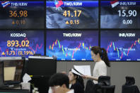 A currency trader reads documents at the foreign exchange dealing room of the KEB Hana Bank headquarters in Seoul, South Korea, Tuesday, Sept. 19, 2023. Asian shares mostly declined in cautious trading Tuesday ahead of the Federal Reserve’s looming decision on interest rates. (AP Photo/Ahn Young-joon)