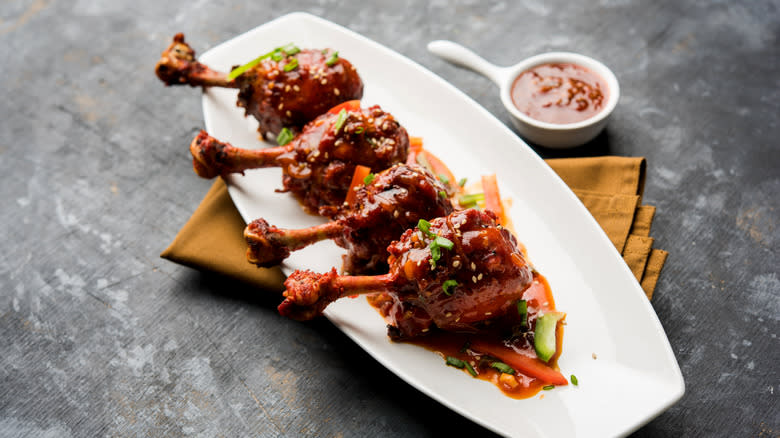 chicken lollipops covered in sauce