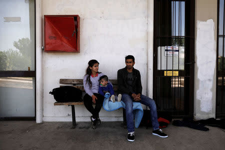 A Syrian refugee family from Afrin, who crossed the Evros river, the natural border between Greece and Turkey, wait at the train station of the city of Orestiada, Greece, April 30, 2018. REUTERS/Alkis Konstantinidis