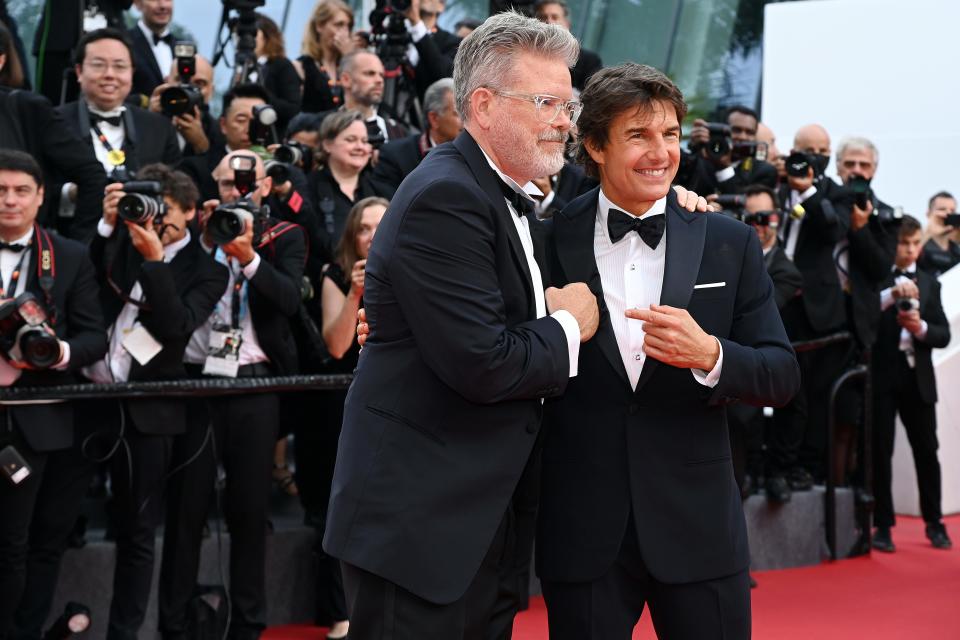 Christopher McQuarrie (left) and Tom Cruise attend the screening of "Top Gun: Maverick" during the 75th annual Cannes film festival at Palais des Festivals on May 18, 2022, in Cannes, France.