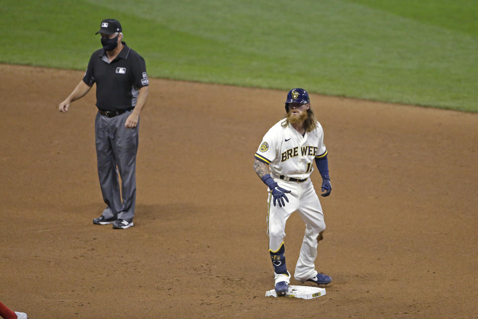 Milwaukee Brewers' Ben Gamel stands on second after hitting an RBI double during the fourth inning of a baseball game against the Cincinnati Reds Tuesday, Aug. 25, 2020, in Milwaukee. (AP Photo/Aaron Gash)