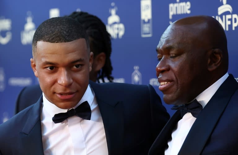 <a class="link " href="https://sports.yahoo.com/soccer/players/3893765/" data-i13n="sec:content-canvas;subsec:anchor_text;elm:context_link" data-ylk="slk:Kylian Mbappe;sec:content-canvas;subsec:anchor_text;elm:context_link;itc:0">Kylian Mbappe</a> (L) arriving with his father Wilfried at French football's annual awards ceremony in Paris on Monday (FRANCK FIFE)
