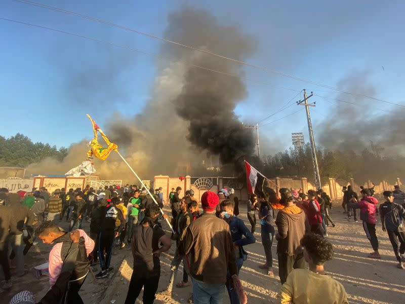 A headquarters building of Popular Mobilization Forces (Hashd al-Shaabi) burns after being torched by demonstrators during ongoing anti-government protests, in Nassiriya