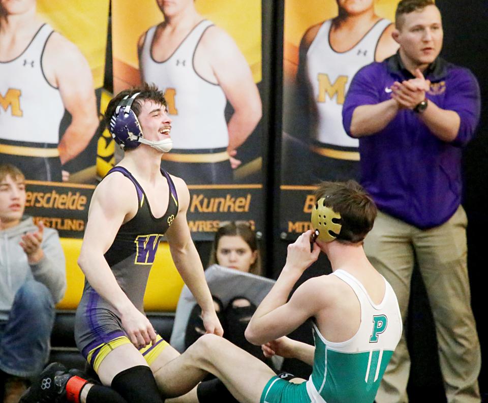 Watertown's Connor Hanson (left) celebrates his overtime victory over Pierre's Nate Williams in the 126-pound championship match Saturday during the Jerry Obroek Invitational wrestling tournament at Mitchell. Looking on at right is Watertown assistant coach Scott Stone. Sloan Johannsen (113) and Draven Bau (220) also won titles for the Arrows, who placed fourth.