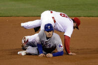 ST LOUIS, MO - OCTOBER 20: Nick Punto #8 of the St. Louis Cardinals turns the double play as Ian Kinsler #5 of the Texas Rangers slides into second base in the sixth inning during Game Two of the MLB World Series at Busch Stadium on October 20, 2011 in St Louis, Missouri. (Photo by Rob Carr/Getty Images)